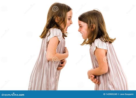 Identical Twin Girls Sisters Are Arguing Yelling At Each Other Stock