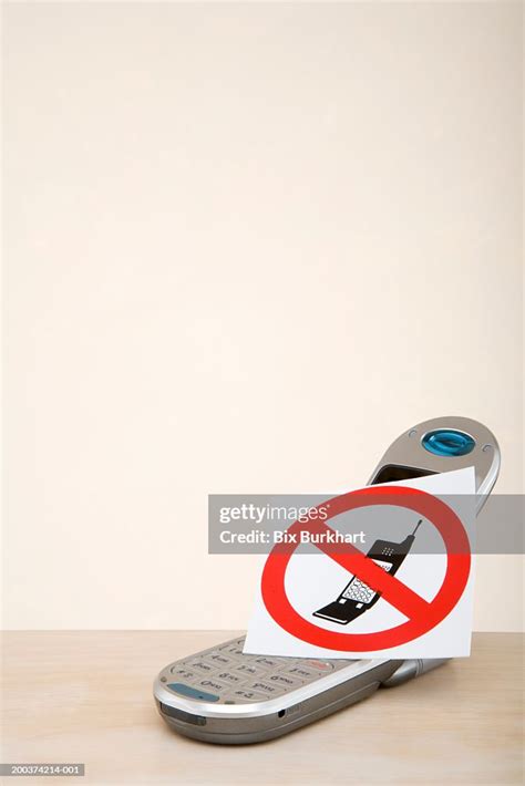 Sign With Mobile Phone Crossed Out Resting On Top Of Mobile Phone High