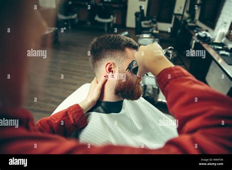 Client During Beard Shaving In Barbershop Female Barber At Salon