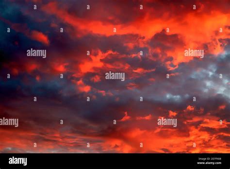 Red Orange Pink Sky With Dark Clouds Hi Res Stock Photography And