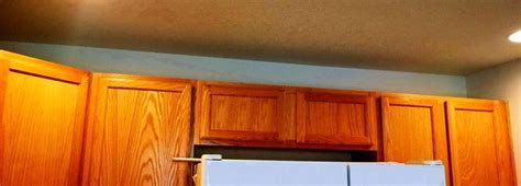 Fasten the crown molding to the top of the cabinet (we used a brad nailer). How To Install Crown Molding To Kitchen Cabinets | RemoveandReplace.com