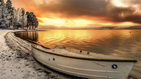 Snow Covered Area Boat Sea Shore During Sunset Under Black Yellow