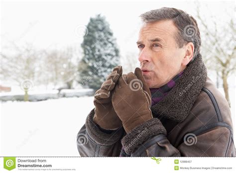 Senior Man Standing Outside In Snowy Landscape Stock Image