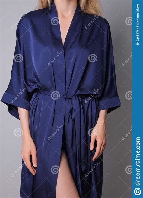 Woman In Beautiful Dark Blue Silk Robe On Grey Background Closeup
