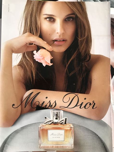 A Magazine Cover With A Beautiful Woman Holding A Flower In Front Of