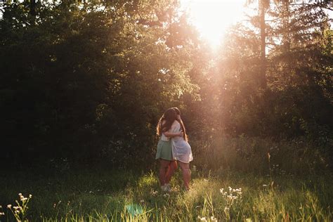 Lesbian Couple Embracing In Forest During Summer Photograph By Cavan Images