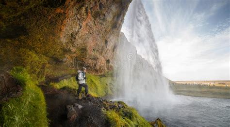 Hiker Woman Looking At The Seljalandsfoss Waterfall Iceland Stock