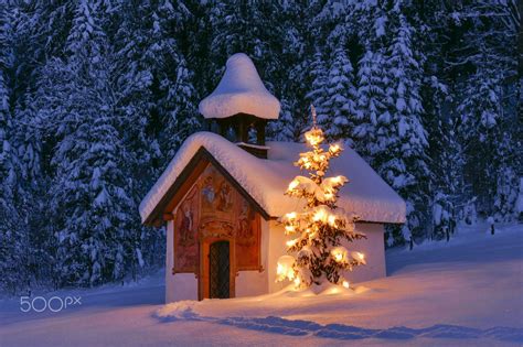 Illuminated Christmas Tree At Chapel In Winter Landscape Bavaria