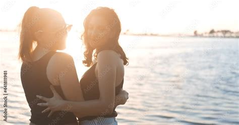 Lesbian Couple Are Caring Each Other Loving Hugging And Kissing On The Beach Seaside Lgbtq