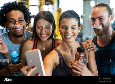 Group Of Sportive People In A Gym Having Fun Taking Selfie Stock Photo