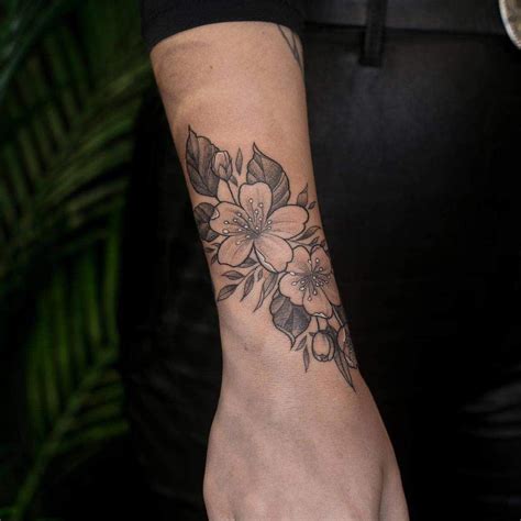 top 37 best flower wrist tattoo ideas [2021 inspiration guide] wrap around wrist tattoos side
