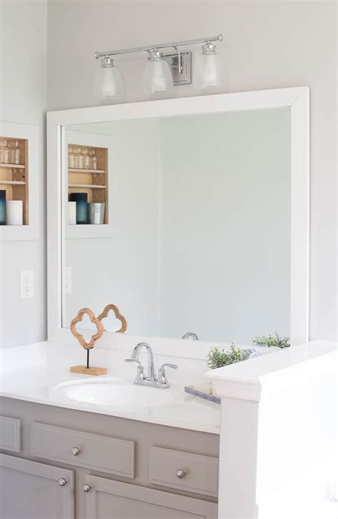 Make a farmhouse style diy mirror frame for your plain clip bathroom mirror. How to Frame a Bathroom Mirror - Easy DIY project