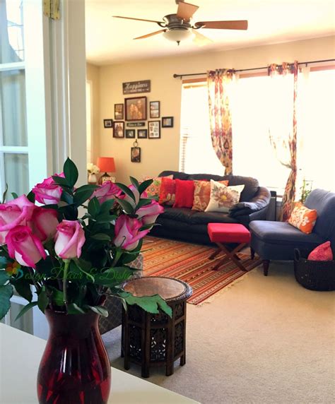A Living Room Filled With Furniture And Flowers In A Vase On Top Of A Table