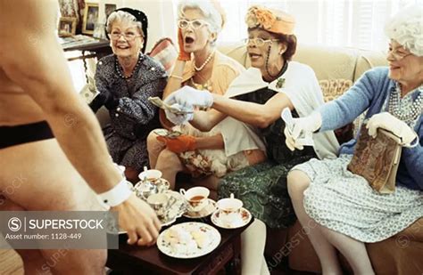 Senior Women Watching Male Stripper At A Tea Party Superstock