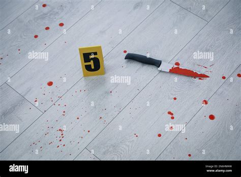 Knife In Blood Near Crime Scene Marker On Wooden Floor Stock Photo Alamy