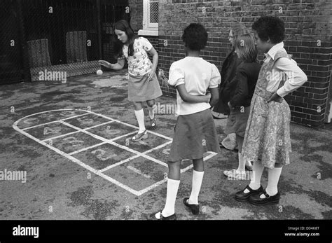 Junior School Children Playing In The Playground Hopscotch Games South