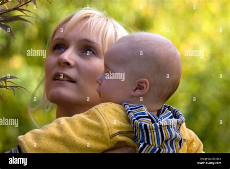 Mother with her baby boy in the garden Stock Photo - Alamy