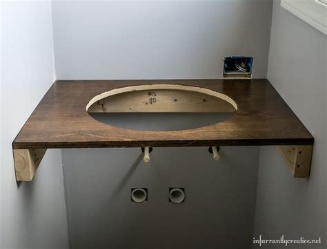 Floating vanities are ideal for bathrooms lacking in space. DIY Floating Wood Vanity - Infarrantly Creative