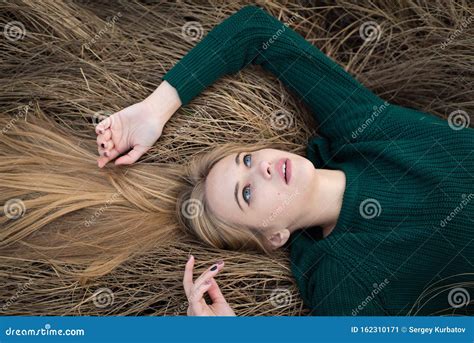 Above View Of Beautiful Redhaired Girl Lying On Grass Posing Embracing Autumn Forest With