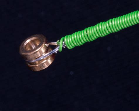 A Green Hose Connected To A Metal Object