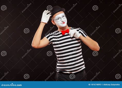 Portrait Of Male Mime Artist Performing Isolated On Black Background