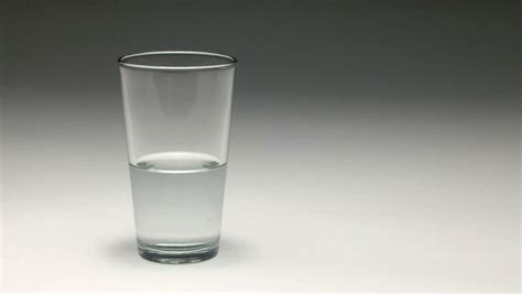 Half Full Glass Of Water Being Filled Studio Shot Stock Footage Video
