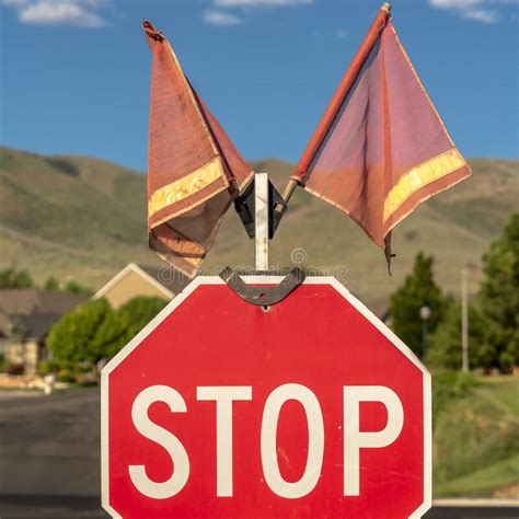 Square Selective Focus Of Traffic Stop Sign With Two Red Flags Against