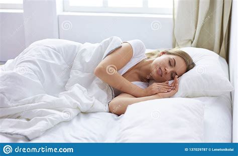 beautiful girl sleeps in the bedroom lying on bed stock image image of morning female 137029787