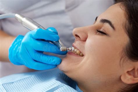 Young Woman Getting Her Teeth Polished In Dental Clinic Professional