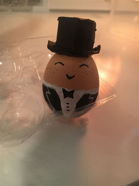An Egg With A Top Hat And Bow Tie On Its Head Sitting On A Table