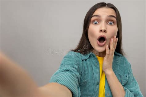 Woman Taking Selfie With Shocked Facial Expression Looking With Big