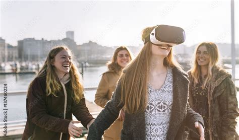 Teenage Girl Using Wearing Vr Glasses While Her Friends Watching Her