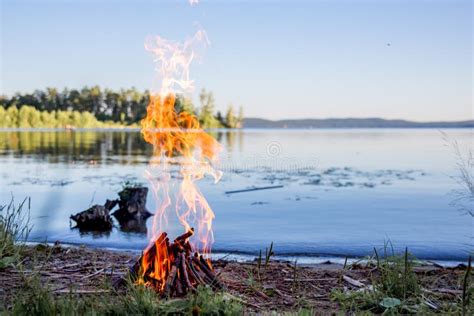 Beautiful Campfire In The Evening At Lake Fire Burning In Dusk At