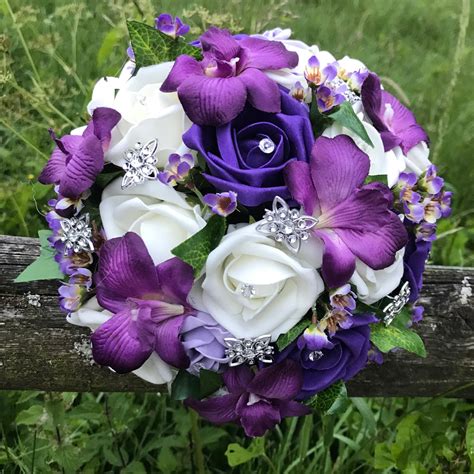 A Brides Wedding Bouquet Of Artificial Ivory And Purple Flowers Abigailrose