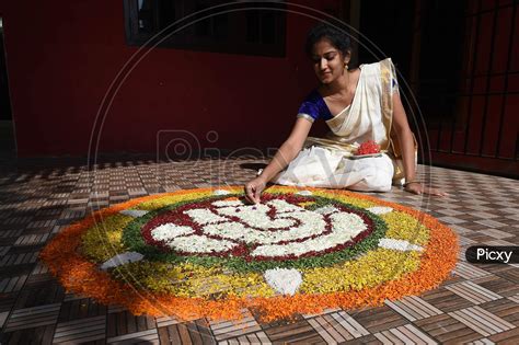 Image Of A Young Woman Prepares Pookalam On The Eve Of Onam Festival In Chennai Monday Aug