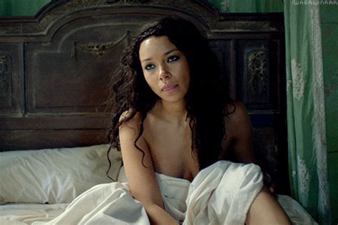 A Naked Woman Sitting On Top Of A Bed