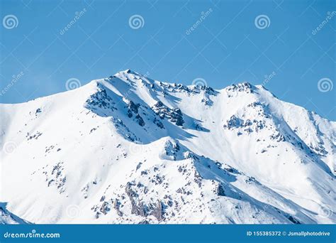Mountain Peaks On Blue Sky Background Snow Capped Mountains Winter
