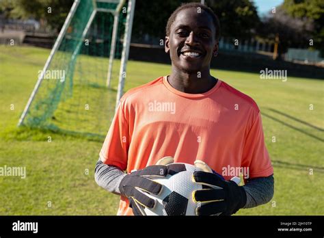 Portrait Of Smiling African American Young Male Goalkeeper Wearing