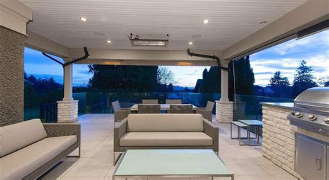 An Outdoor Living Area With Couches And Grill