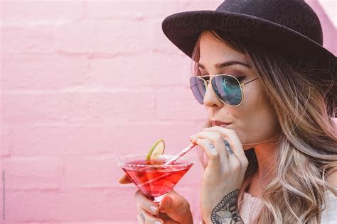 Party Girl Drinking A Cocktail Through A Straw By Stocksy Contributor Jodie Johnson