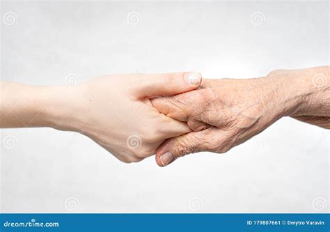 Helping Hand For The Elderly Concept With Young Hand Holding Old Hand