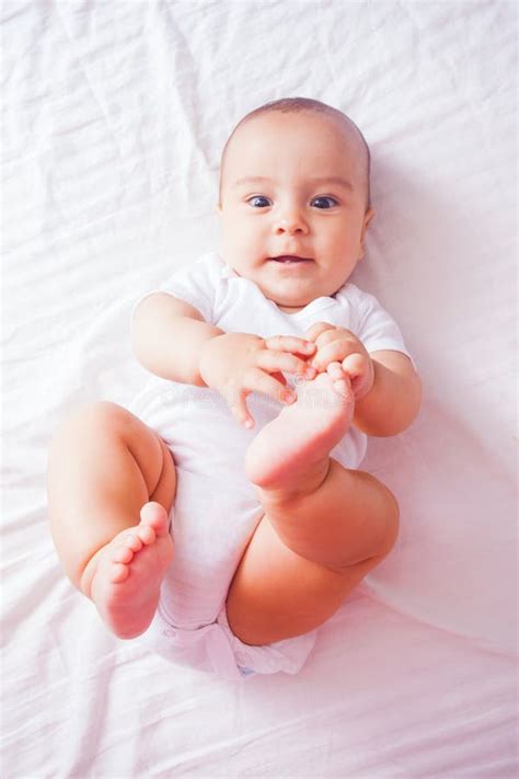 Portrait Of A Baby Lying On The Bed Stock Photo Image Of Bedding