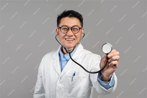 Premium Photo Cheerful Confident Mature Japanese Doctor In White Coat
