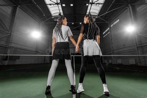 woman tennis player posing like a fitness fashion model on tennis court lesbian couple holding