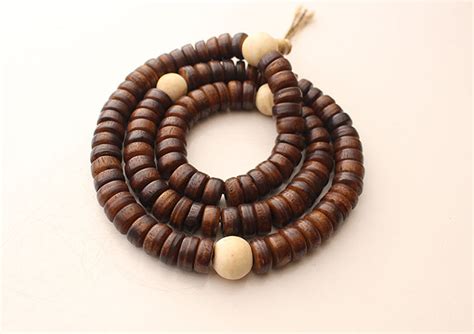 disk shaped brown yak bone japa mala with white conch counter