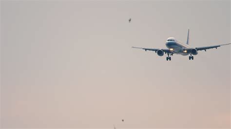 Jet Airplane Descending To Land At Phuket Airport Long Shot From A