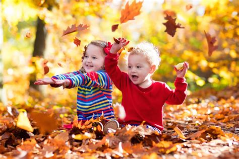 Kids Playing With Golden Maple Leaves In Sunny Autumn Park Loans 2 Go