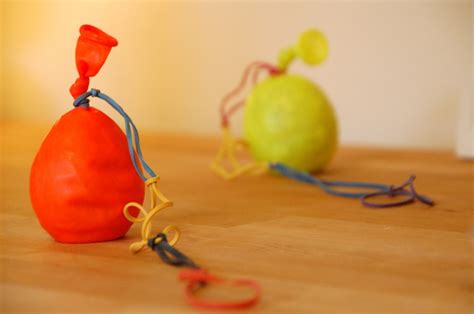 This video will show you how to do this trick. Simple Balloon Yo-Yo | TinkerLab