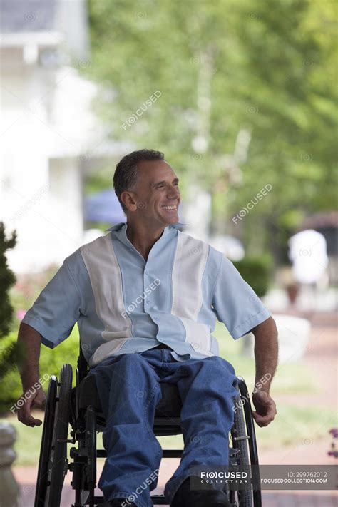 Man With Spinal Cord Injury In A Wheelchair Enjoying Outdoors Casual
