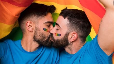 Young Homosexual Couple Of Men Kissing On Lgbt Flag Photo Free Download